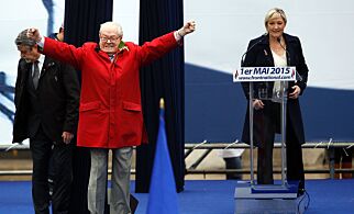 (FILES) This file photo taken on May 01, 2015 shows France's far-right political party Front National (FN) founder and honorary president Jean-Marie Le Pen gesturing on stage as FN's president Marine Le Pen looks during the party's annual rally in honour of Jeanne d'Arc (Joan of Arc), in Paris.
Front National (National Front - FN) leader Marine Le Pen arrived slightly behind the pro-European centrist candidate with 21.53 percent of the votes in the first round of France's Presidential election on April 23, 2017.
/ AFP PHOTO / KENZO TRIBOUILLARD
